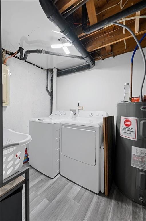 laundry room featuring separate washer and dryer, light hardwood / wood-style floors, and water heater