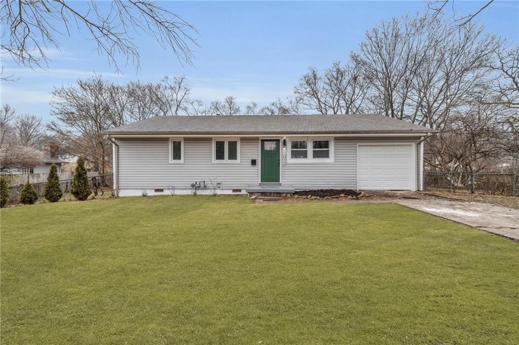 view of front of property with a garage and a front yard