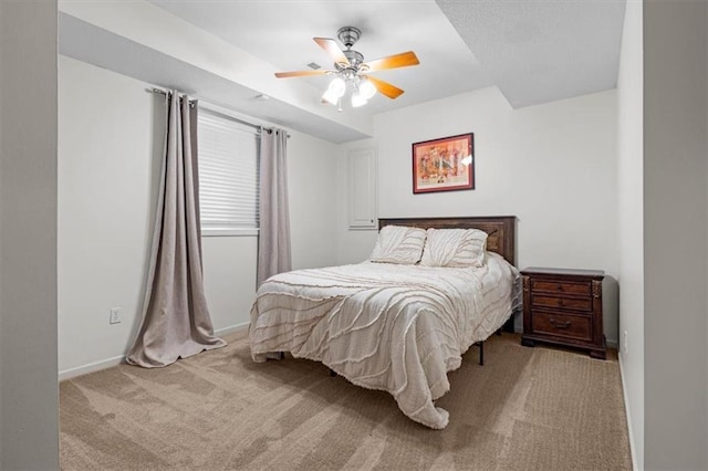 bedroom with ceiling fan and light colored carpet