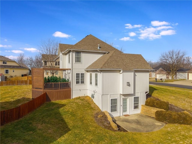 rear view of house featuring a yard and a patio