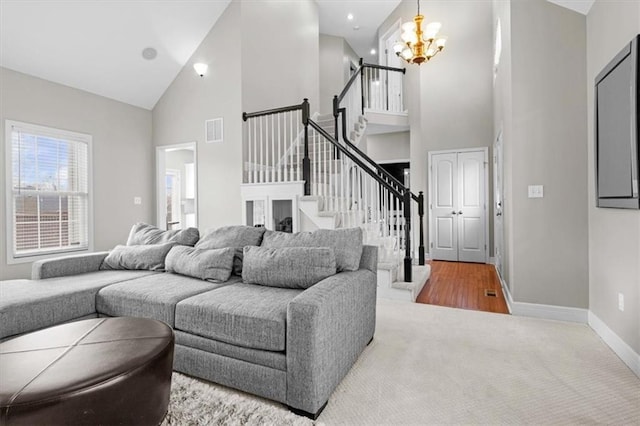 living room with an inviting chandelier, wood-type flooring, and high vaulted ceiling