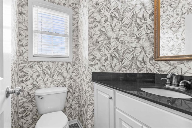 bathroom featuring vanity and toilet