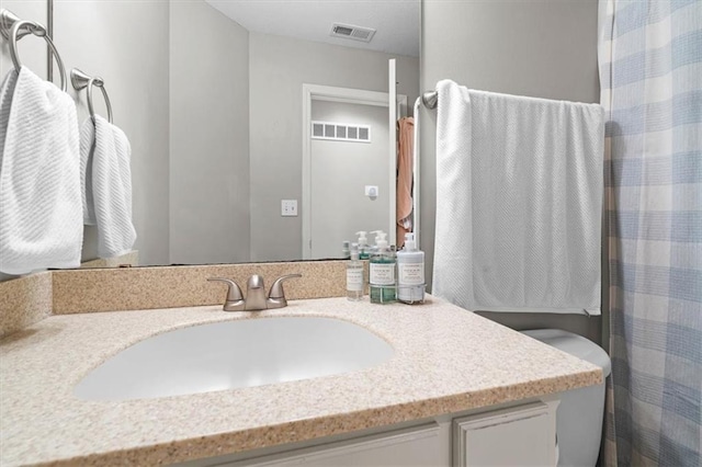 bathroom with vanity and toilet