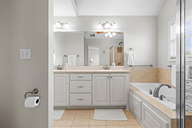 bathroom with ceiling fan, vanity, plus walk in shower, and tile patterned flooring