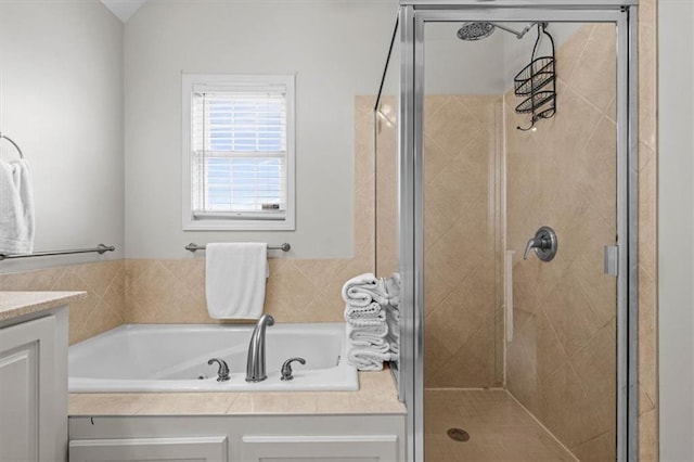 bathroom featuring vanity and shower with separate bathtub