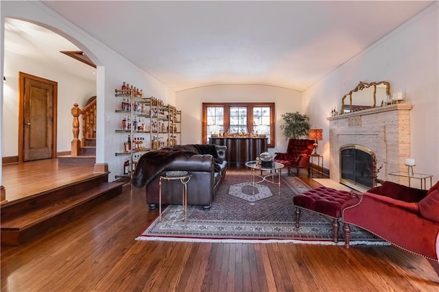 living room featuring vaulted ceiling and wood-type flooring