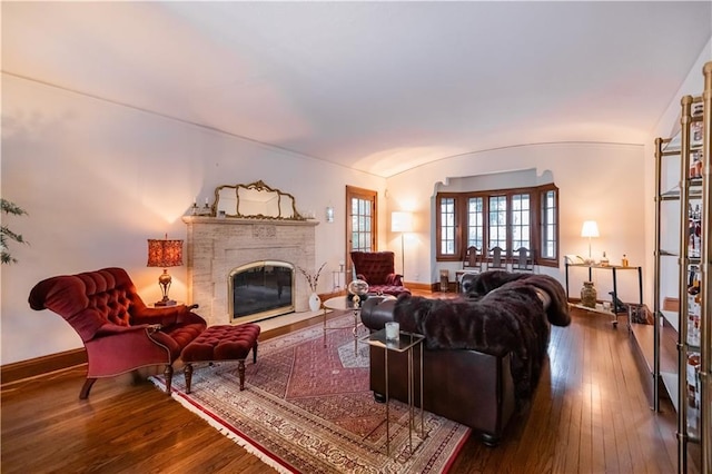 living room with hardwood / wood-style flooring and lofted ceiling