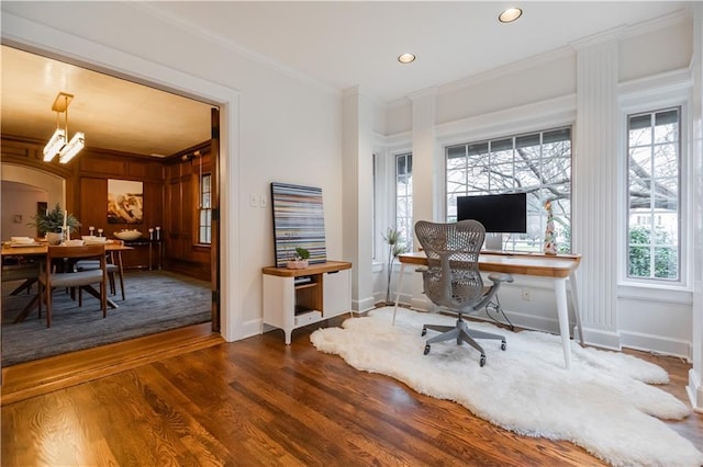 office space featuring dark wood-type flooring and crown molding