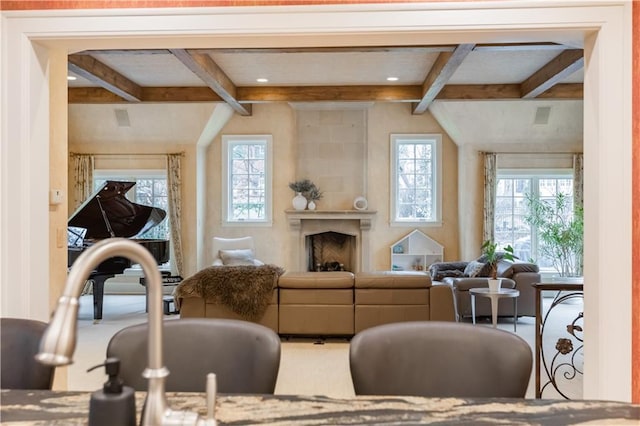 interior space with carpet, a wealth of natural light, and beam ceiling