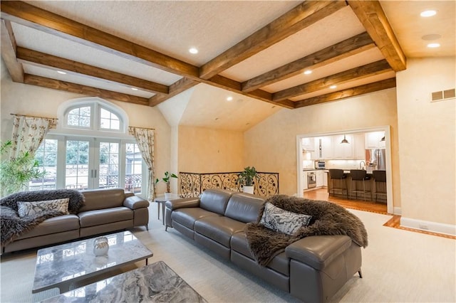 living room featuring lofted ceiling with beams and french doors