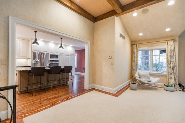 interior space featuring dark hardwood / wood-style flooring and lofted ceiling with beams