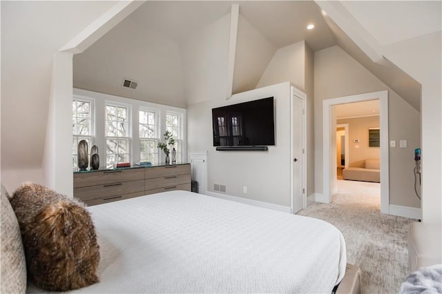 carpeted bedroom with lofted ceiling