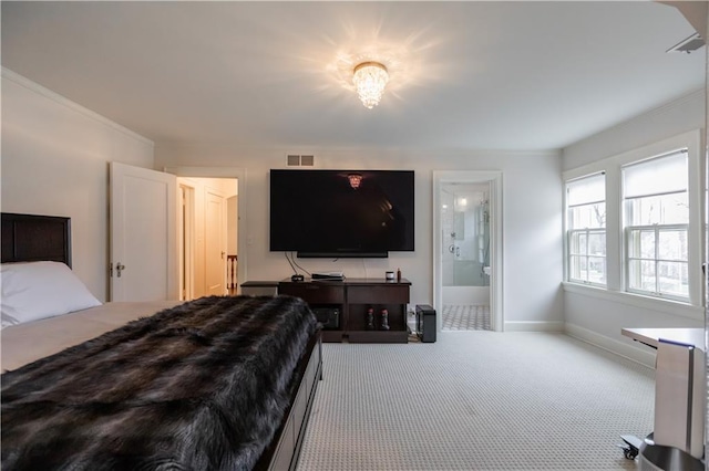 carpeted bedroom with ensuite bath and crown molding