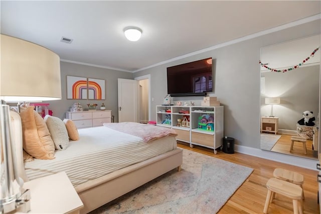 bedroom featuring hardwood / wood-style flooring and crown molding