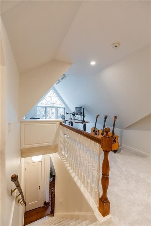 stairway featuring lofted ceiling