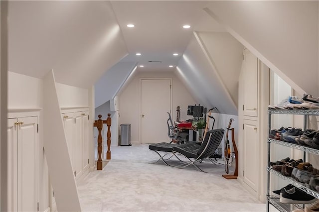 additional living space featuring vaulted ceiling and light carpet