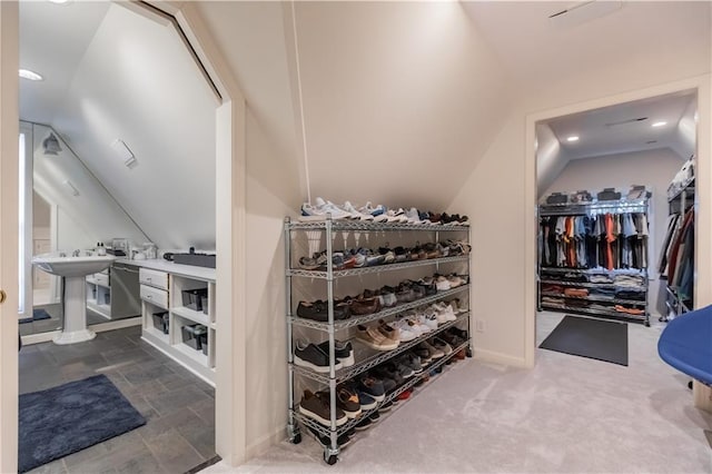 spacious closet with carpet flooring and vaulted ceiling