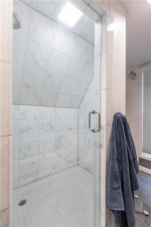 bathroom featuring a shower with door