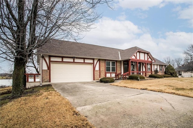 tudor-style house with a garage, covered porch, and a front yard