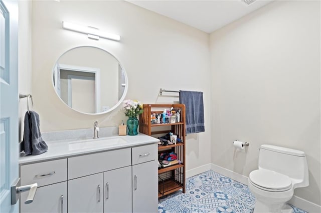 half bath featuring toilet, baseboards, and vanity
