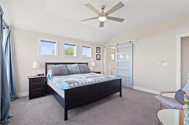 bedroom with carpet floors, baseboards, a barn door, and lofted ceiling
