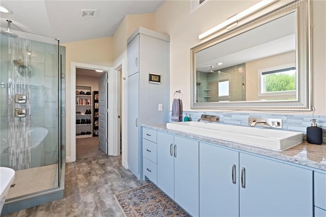 full bath with visible vents, decorative backsplash, a stall shower, and vanity