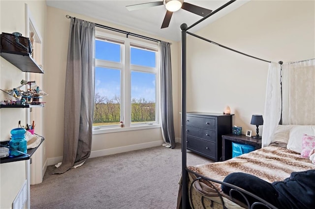 bedroom with baseboards, a ceiling fan, and light colored carpet