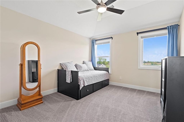 carpeted bedroom with baseboards, a ceiling fan, and vaulted ceiling