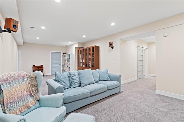 living area with baseboards, recessed lighting, a barn door, and light colored carpet