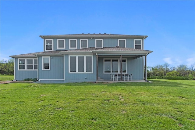 back of property with a patio and a yard
