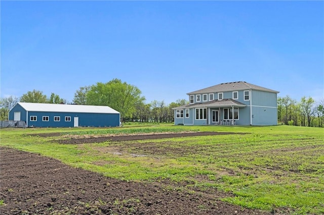 rear view of property featuring a yard