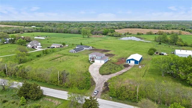 birds eye view of property featuring a water view and a rural view