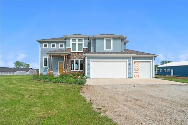prairie-style house with a front yard and concrete driveway