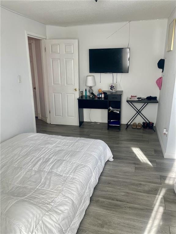 bedroom with dark hardwood / wood-style flooring