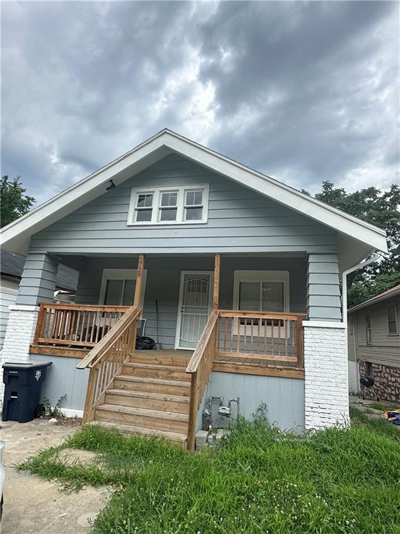 rear view of house with covered porch