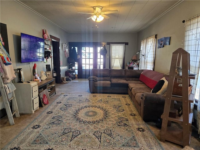 living room featuring ornamental molding, carpet, and ceiling fan