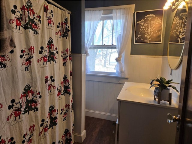 bathroom featuring vanity, wood-type flooring, and wood walls