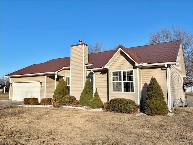 view of property exterior featuring a garage and a lawn