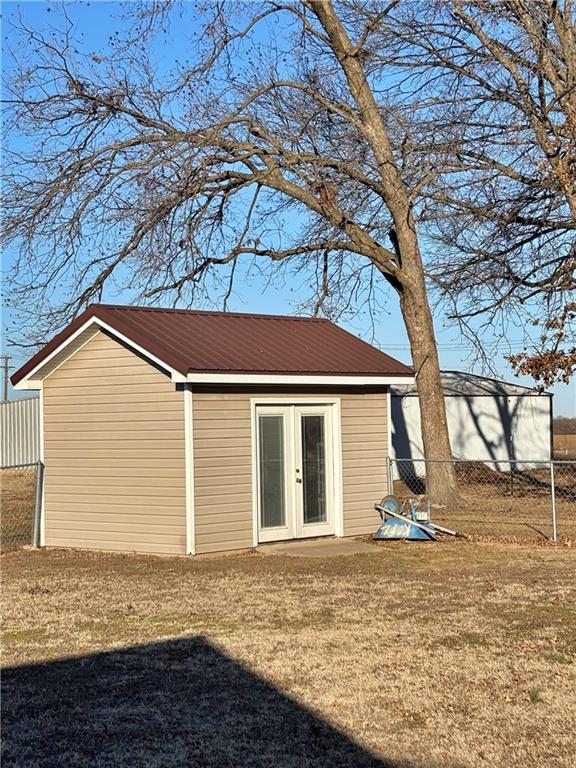 exterior space featuring french doors and fence