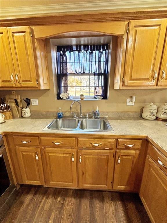 kitchen with dark wood-type flooring, light countertops, a sink, and wall oven