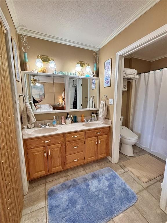 bathroom with a textured ceiling, double vanity, ornamental molding, and a sink