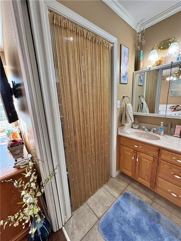 bathroom featuring a textured ceiling, vanity, and crown molding