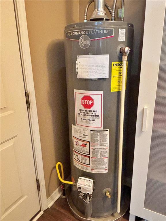 utility room featuring water heater