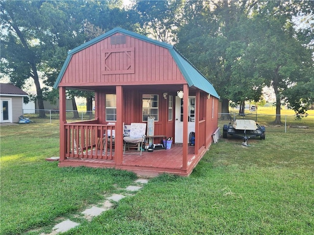 view of outbuilding with fence and an outbuilding