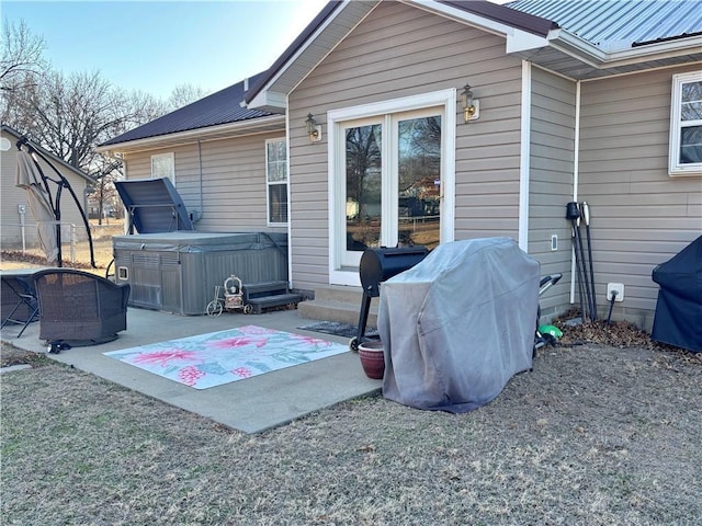 view of patio / terrace featuring a hot tub and a grill