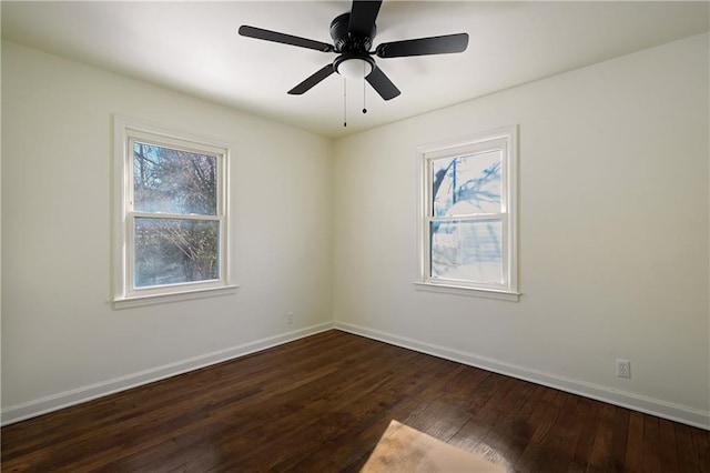 unfurnished room featuring ceiling fan, dark hardwood / wood-style floors, and a healthy amount of sunlight