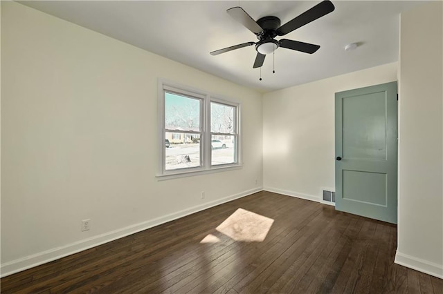 spare room featuring dark hardwood / wood-style floors and ceiling fan