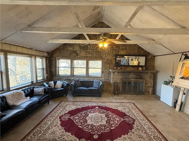 living room with vaulted ceiling with beams and a fireplace