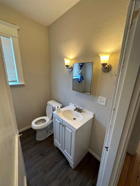 bathroom featuring vanity, hardwood / wood-style flooring, and toilet