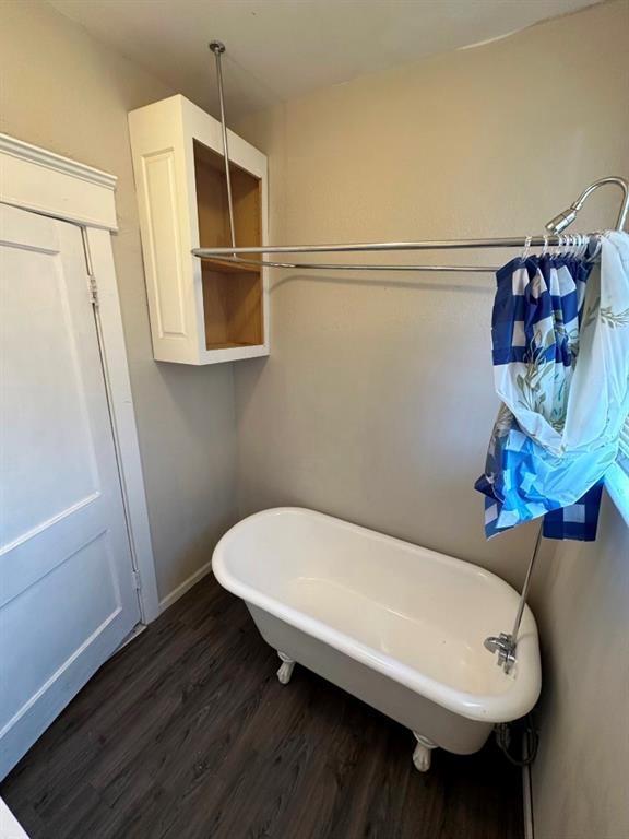 bathroom featuring a washtub and hardwood / wood-style floors